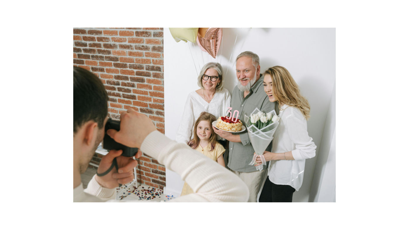 Family celebrating a milestone birthday with cake, balloons, and flowers, posing for a quick photo, representing the joy and convenience of last-minute birthday gift solutions with same-day and rush delivery.