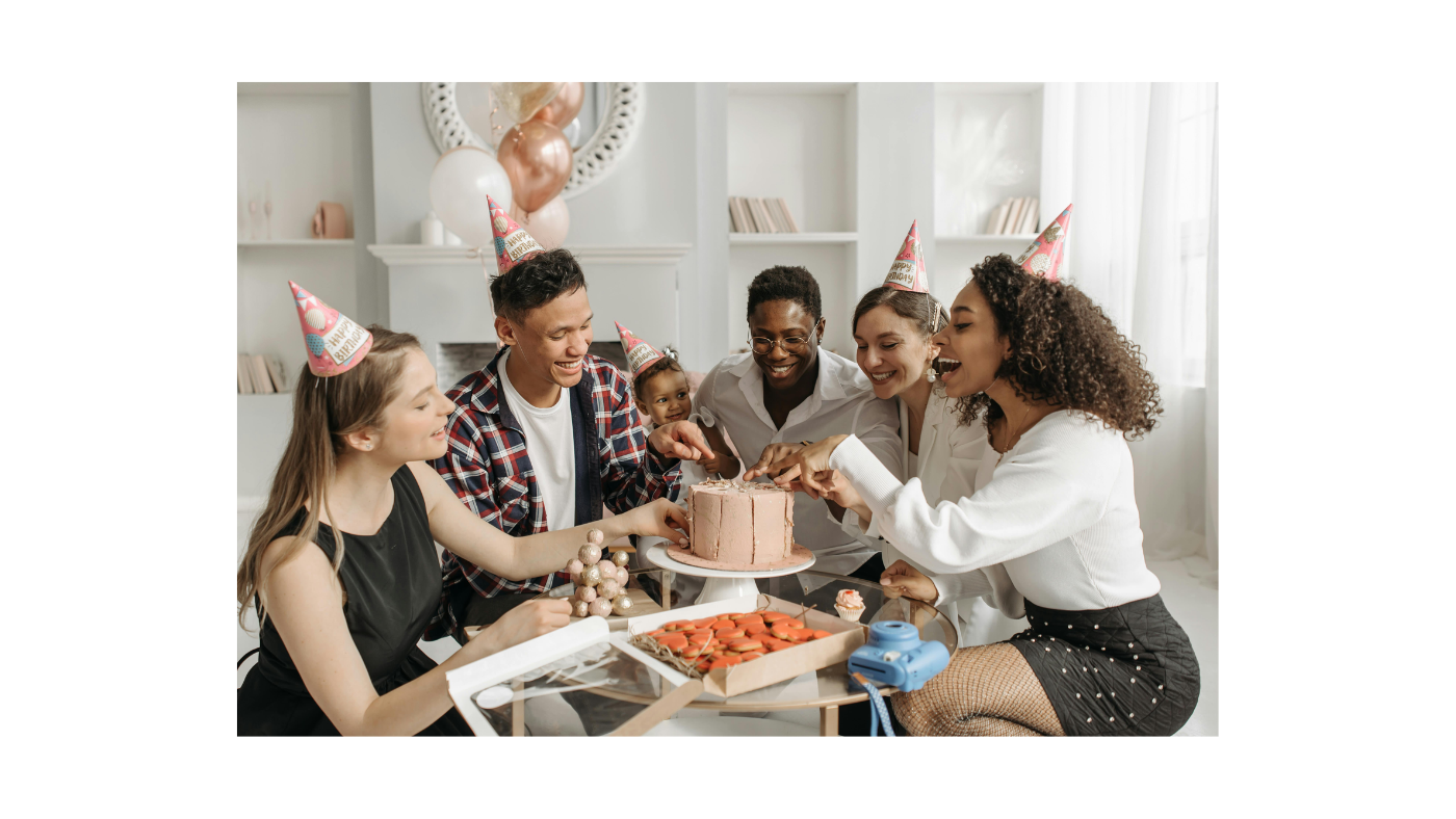 Diverse group of friends wearing party hats sharing cake and chocolates at a joyful birthday celebration, highlighting the importance of building birthday gift traditions that create lasting memories together