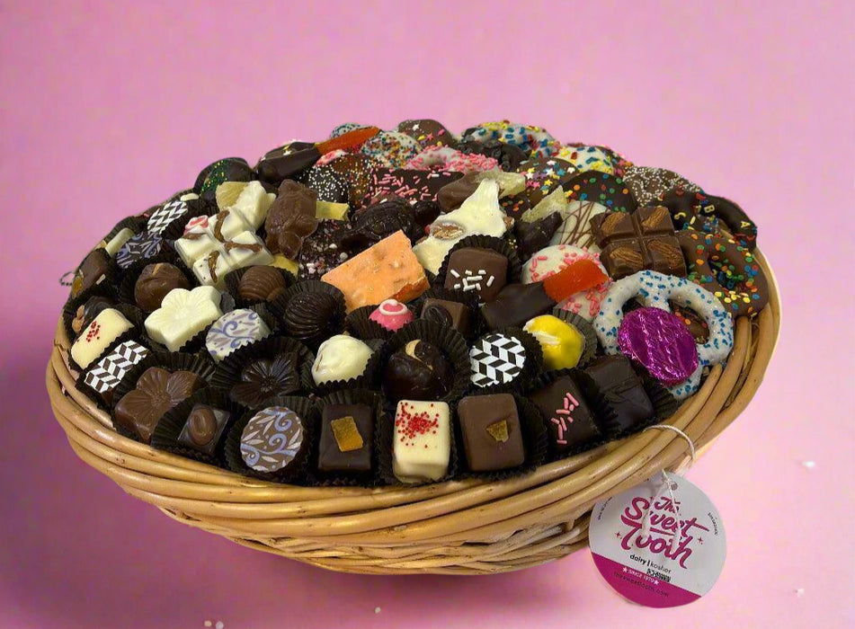EXTRA LARGE - Birthday food gift basket filled with assorted gourmet chocolates, truffles, and colorful candy treats in a woven basket.