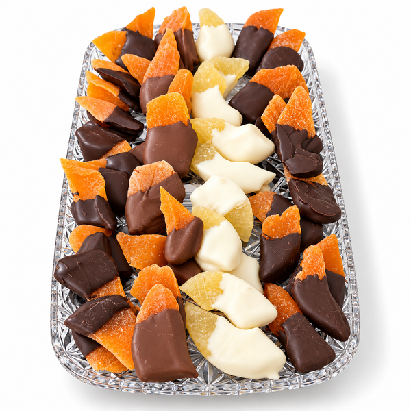 Chocolate dipped dried fruit in milk, dark and white chocolate on a clear tray from The Sweet Tooth