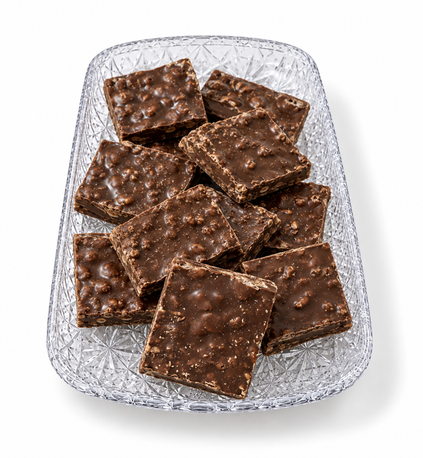 Chocolate Krisp Bark squares with crisp rice on a clear tray from The Sweet Tooth