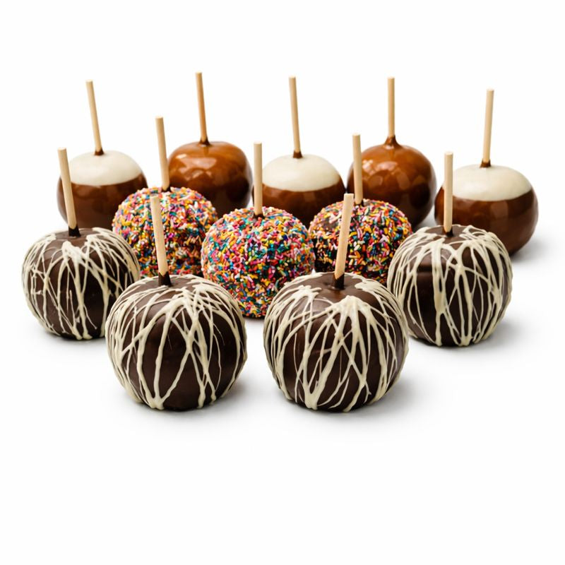 Assorted chocolate-dipped apples with different toppings on a white background