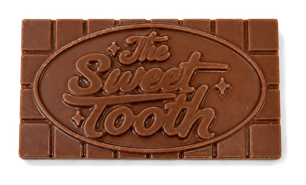 A milk chocolate bar with The Sweet Tooth logo on it