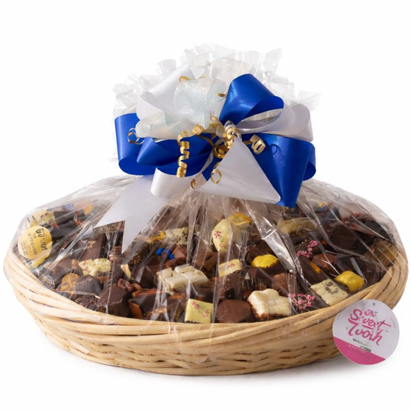 Handmade chocolate gift basket with a decorative bow for Christmas gifting from The Sweet Tooth