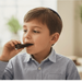 Young boy eating chocolate in a casual indoor setting Rosh Hashana 