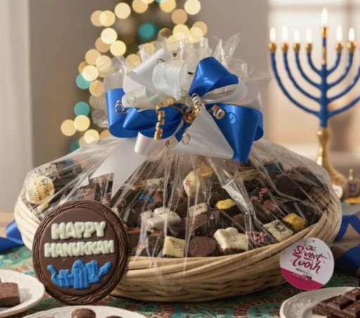 Gift basket with a blue and white bow, surrounded by festive decorations including a Menorah and blurred lights.