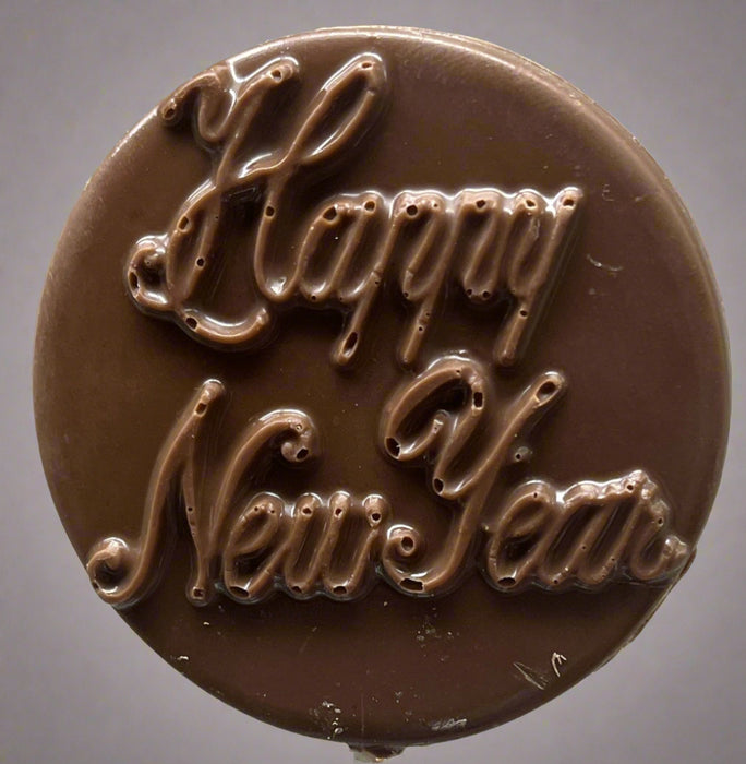 Chocolate candy with 'Happy New Year' text on a gray background