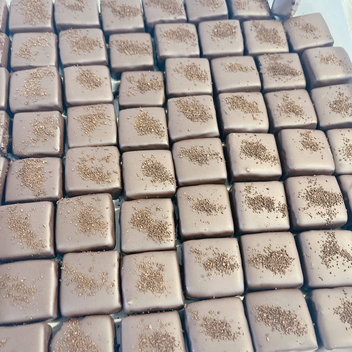 Square chocolate truffles dusted with cocoa powder, featured in the EXTRA LARGE - Passover kosher chocolate gift basket.