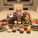Assorted chocolate truffles and confections on a table with a blurred kitchen background