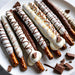 Gourmet Pretzel Rods Dipped in Chocolate with white chocolate coating and toppings, perfect for birthdays or Rosh Hashanah treats.