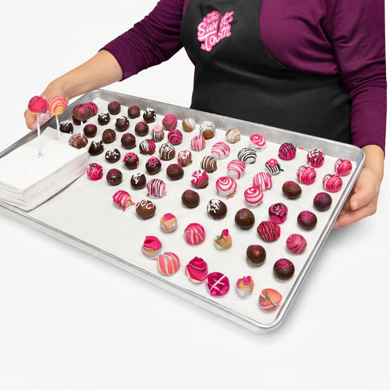 
Assorted new seasonal flavors of kosher chocolate truffles decorated by hand on a tray The Sweet Tooth North Miami Beach since 1979