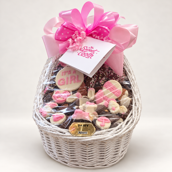 Baby Girl Bassinet with pink bow and chocolates