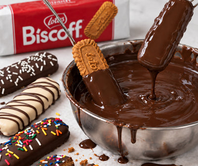 Chocolate-dipped Biscoff cookies being dipped in melted chocolate at The Sweet Tooth