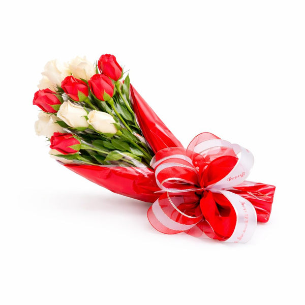 Bouquet of red and white flowers wrapped in cellophane with a decorative bow wrapped with ribbon, handcrafted gift, The Sweet Tooth North Miami Beach since 1979