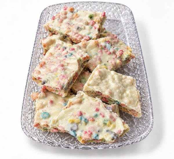 Fruity Pebbles white chocolate bark on a glass tray