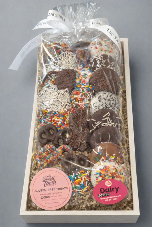 Box of gluten-free treats with sprinkles and a visible brand label on a gray background