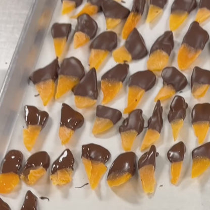 Dried mango being dipped in chocolate at The Sweet Tooth