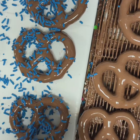 Chocolate dipped pretzels with blue sprinkles