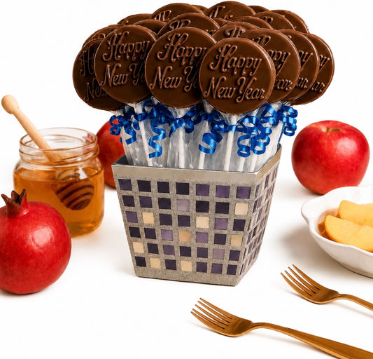 Rosh Hashanah chocolate lollipops gift set — 18 'Happy New Year' chocolate pops with blue ribbon in a silver mosaic box, styled with apples, honey, and pomegranates