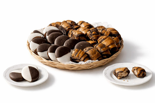 
A wicker basket filled with Sonnny's famous black & white cookies with chocolate rugelach, arranged on a clean white studio background. A mix of soft cookies and rich pastry pieces ready for gifting or sharing.