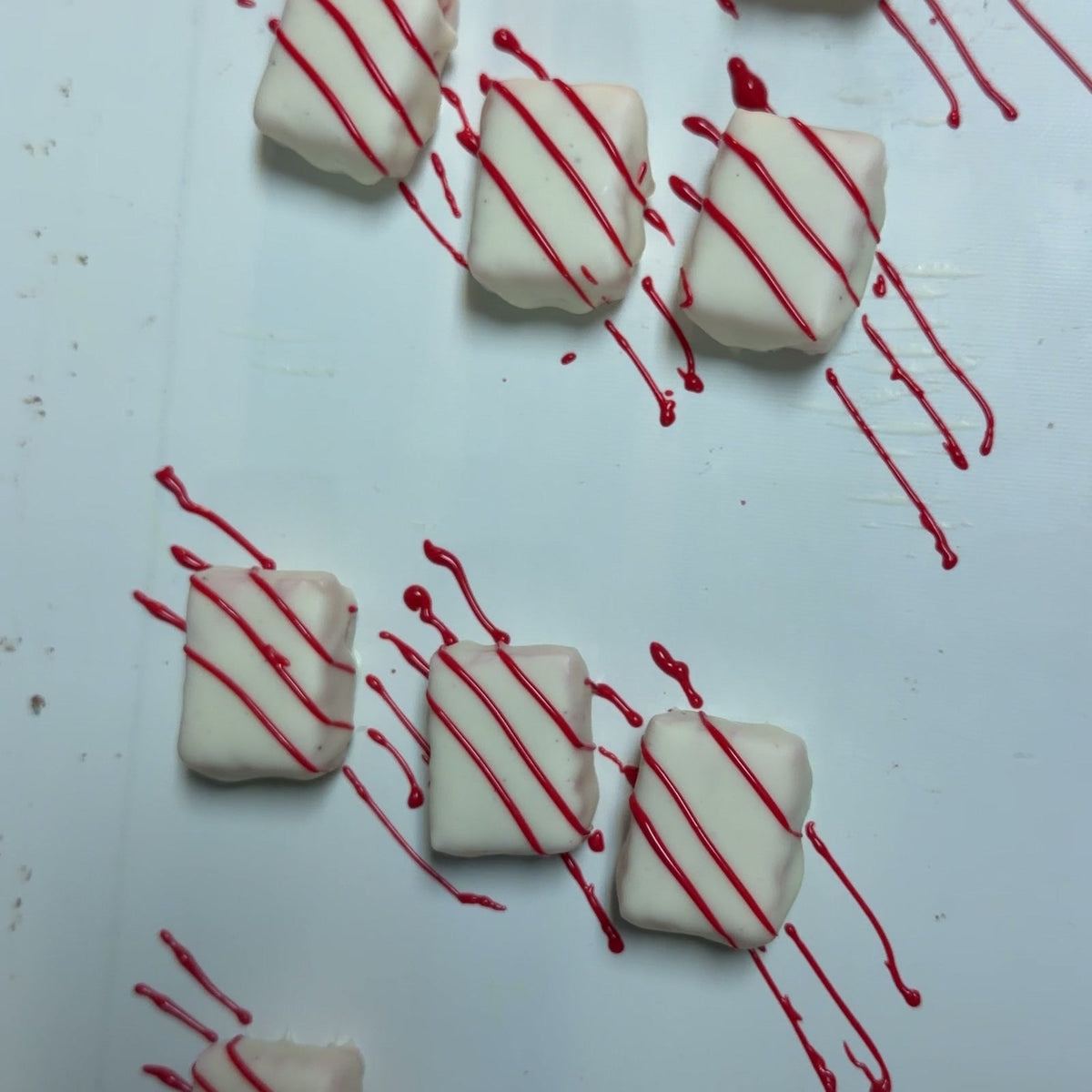 White chocolate truffles with red stripes from The Sweet Tooth