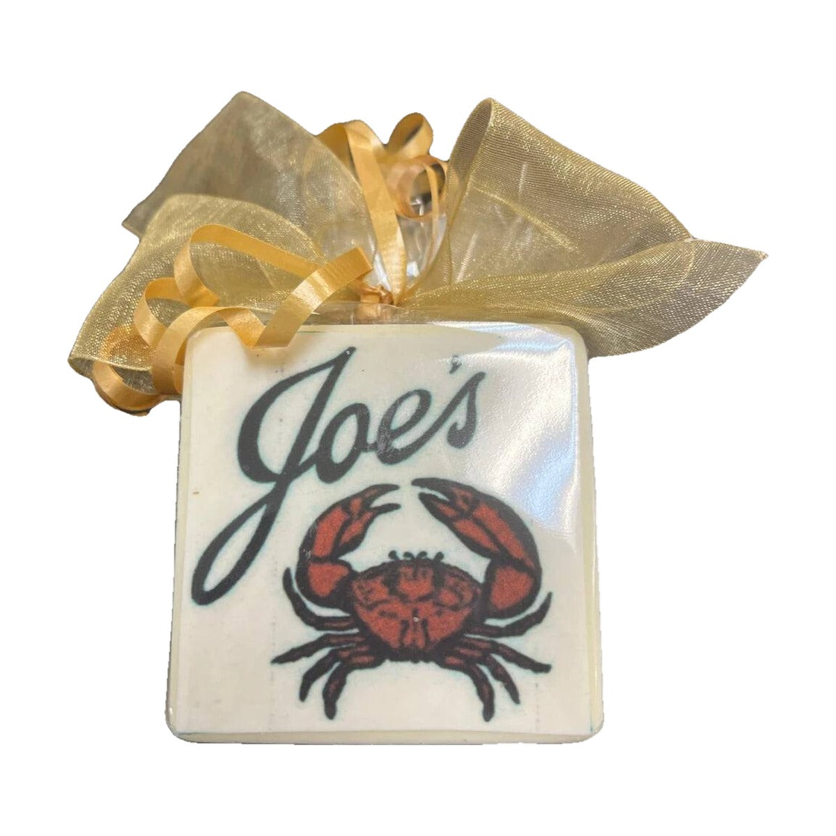 A chocolate bar printed with a restaurant logo and tied with a gold ribbon, made by The Sweet Tooth